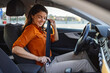 © Graphicroyalty - Young woman sitting on car seat and fastening seat belt, car safety concept. Woman fastens a seat belt in the car. Caucasian woman driver fastening car seat belt while sitting behind the wheel car.