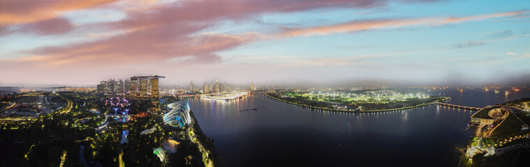 Wall Mural - Singapore and Marina Bay skyscrapers. Aerial view at night from drone