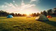 Field Tents Group on Green Lawn in Outdoors Campsite area of Natural Park at Morning time