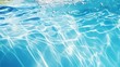 Clear water surface with ripple wave splashes and drops in swimming pool. Abstract turquoise or blue texture water wave and sunlight shadow reflections for background