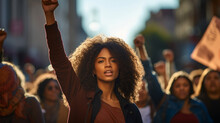Black Woman Marching In Protest With A Group Of People