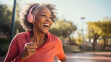 Senior Black Woman Listening Music At Park