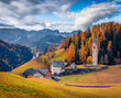Astonishing autumn view of San Genesio and Santa Barbara churches. Gloomy morning scene of Tolpei village, Province of Bolzano - South Tyrol, Italy. Beauty of countryside concept background.