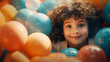 © MD Media - Happy little girl having fun in ball pit in kids indoor play center. Child playing with colorful balls in playground ball pool.