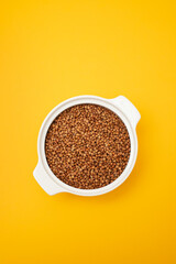 Sticker - Raw toasted buckwheat in a white ceramic bowl