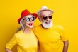 happiness travel couple old age retired person casual cloth studio shooting in happiness travel theme on yellow backdrop background