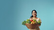 © PRASANNAPIX - Young woman holding a basket full of fresh fruits and vegetables