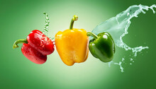 Red, Yellow And Green Peppers With Water Splash 