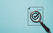 Correct sign symbol inside magnifier glass on document icon for ISO quality assurance control and project approve concept.