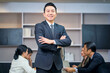 © bank215 - Smart and smil face of businessman boss stand in meeting room with team.