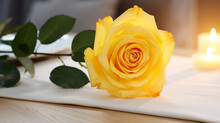 Yellow Rose And Candle On Wooden Table With Blurred Background
