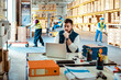 © Marko Geber - Young male warehouse supervisor working on a laptop