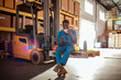 © Marko Geber - Young African American forklift operator having a lunch break in a warehouse