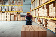 © Marko Geber - Senior African American worker pushing a rolling cart with boxes in a warehouse