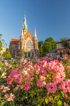 Krakow, Poland, St Joseph Church In Podgorze District Over Blooming Roses.