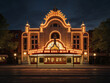 A glamorous theater adorned with a brightly lit marquee that shines in the night sky.