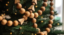 Sustainable christmas trees eco-friendly ethical decorations. Natural Wooden beads garland on Christmas tree. Eco friendly zero waste Christmas tree decor