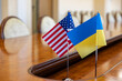 flags of United States and Ukraine. international negotiations. conclusion of contracts between countries. concept of communication between representatives of two countries.