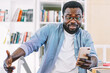© BullRun - Shocked adult man checking news on cellphone sitting in office