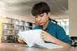 © PolacoStudios - student in library