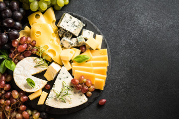 Sticker - Cheese platter with craft cheese assortment and grape on slate board. Flat lay with space for text.