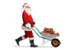 © Ljupco Smokovski - Full length shot of santa claus pushing a wheelbarrow with bricks