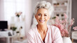 Contemporary adult woman with short gray hair smiling and posing for the camera. Portrait of a happy successful lady