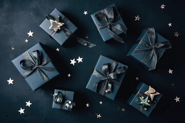 Wall Mural - Black Christmas gifts on black background with star confetti