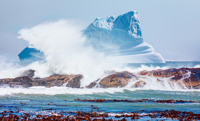 Giant iceberg with rocky coastline and strong sea wave - Greenland