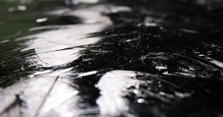 Black shiny carbon coating abstract closeup 4k movie. Hard materials concept
