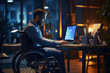 IT programmer with disability in a wheelchair working on computer. Male specialist creating inspirational software.
