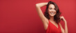 Smiling beautiful woman on solid red background