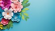 top view of colorful paper cut flowers with green leaves on blue background with copy space 