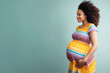 An elegant expecting African American mother, her hands tenderly embracing her growing belly in a heartwarming maternity portrait.