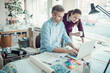 © Geber86 - Young man and woman using the laptop while working together on a project in a startup company office