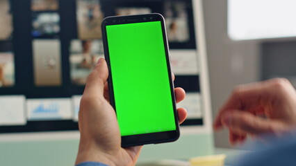 Wall Mural - Freelancer finger scrolling greenscreen smartphone closeup. Man mockup cellphone