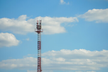 New GSM antennas on a high tower against a blue sky for transmitting a 5g signal are dangerous to health. Radiation pollution of the environment through cell towers. The threat of extinction