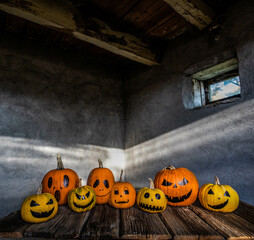 Wall Mural - scary funny Halloween pumpkins on wooden table