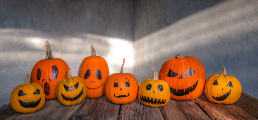 Wall Mural - scary funny Halloween pumpkins on wooden table