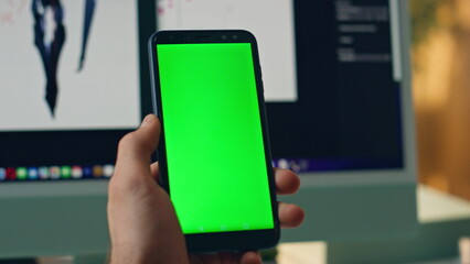 Wall Mural - Man hands holding mockup mobile phone office closeup. Artist using chromakey app