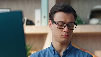 Wall Mural - Serious man answering cellphone call at office closeup. Guy calling smartphone