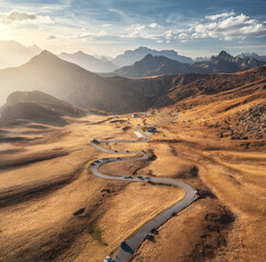 Wall Mural - aerial view of road in mountain valley, golden sunlight at sunset in autumn. passo giau, dolomites, 
