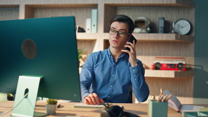 Wall Mural - Confident startuper making call at corporate office closeup. Man chatting phone