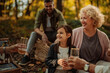 © bernardbodo - Caucasian family having a picnic in the forest while drinking juice