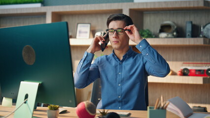 Wall Mural - Chatting man having telephone call at workplace. Startuper calling mobile phone