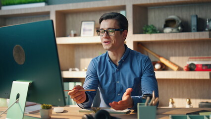 Wall Mural - Confident man talking virtual call modern office closeup. Freelancer gesturing