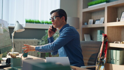 Wall Mural - Creative businessman sipping tea in work place closeup. Freelancer talking phone