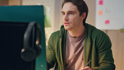Wall Mural - Pensive freelancer drawing tablet modern office closeup. man watching computer