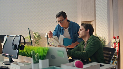 Wall Mural - two designers choosing colour looking monitor business place. men brainstorming