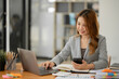 © Thitisak - Asian businesswoman working on documents at office